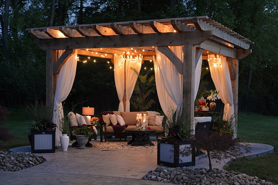 outdoor space at night with cozy furniture and lights